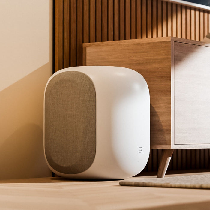 Bluesound PULSE SUB Wireless Subwoofer lifestyle shot, in white