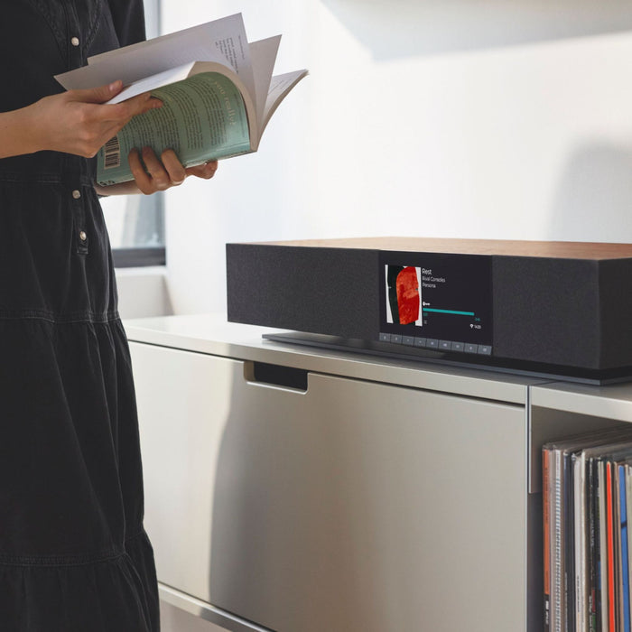 Cambridge Audio EVO One All-In-One System lifestyle photo, EVO in living room setting with person reading