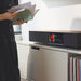 Cambridge Audio EVO One All-In-One System lifestyle photo, EVO in living room setting with person reading