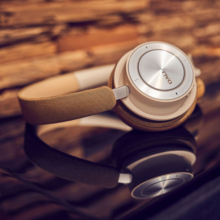 DALI IO-8 Wireless HiFi Headphones, caramel white detail view, in upscale setting