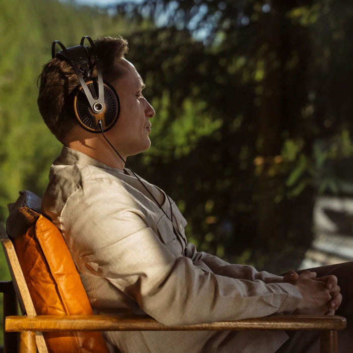 Person listening to Meze 105 Silva Open-Back Headphones