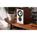 Mission 750 bookshelf speaker, walnut finish, lifestyle view showcasing elegant design