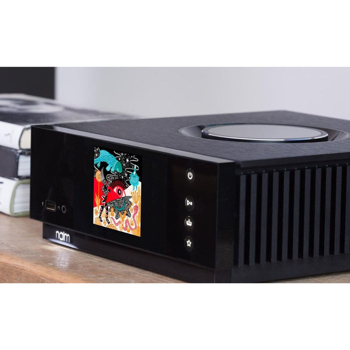 Naim Uniti Atom All-In-One Wireless Music Player, lifestyle view in listening room with colorful album art