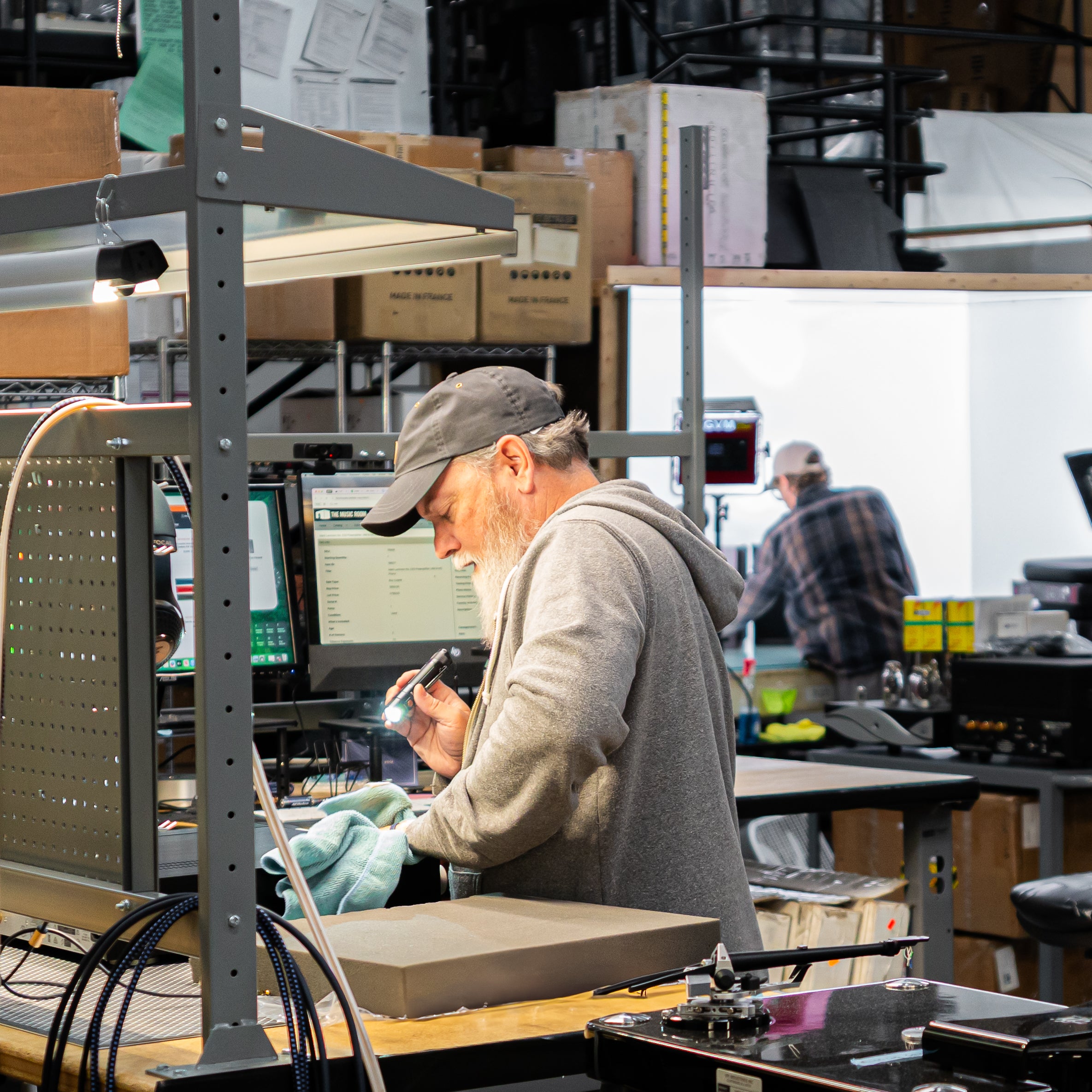 Staff inspecting an amplifier inside TMR HQ